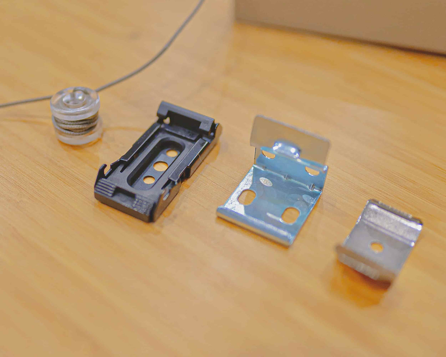 Three kinds of RV shade mounting bracket examples on a table.